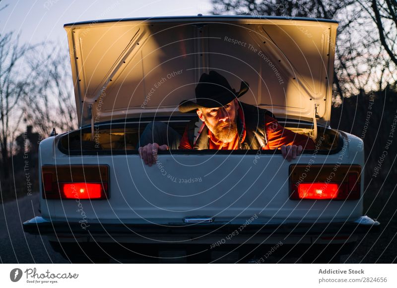 Man in trunk of vintage car Car Vintage Retro White Trunk hiding Hat Evening Vehicle Classic Old Adults Vacation & Travel Human being Transport Drive Elegant
