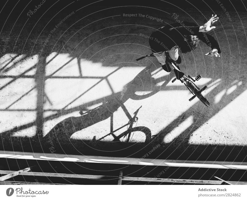 BMX rider performing tricks BMX bike Man Jump Bicycle Sports Trick Youth (Young adults) Lifestyle in motion Action Extreme Black & white photo Rider