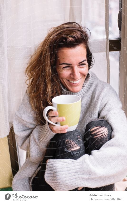 Cheerful woman relaxing with cup Woman Home Relaxation Lifestyle Cup Mug Drinking Hot Smiling Coffee Tea Beautiful Room Human being Easygoing Adults