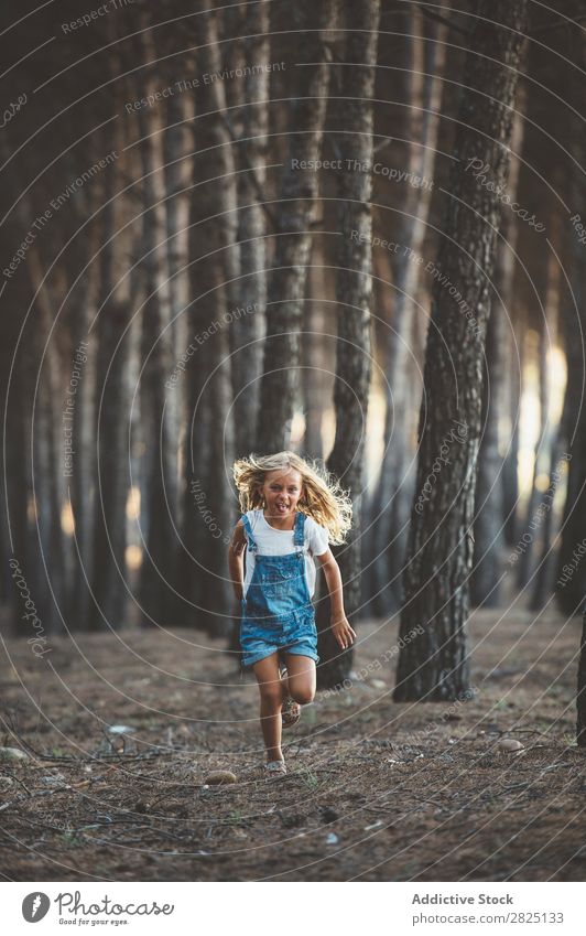 Happy child running in forest Girl Happiness Forest Action Running Freedom grimacing showing tongue Recklessness in motion Leisure and hobbies Nature Innocent