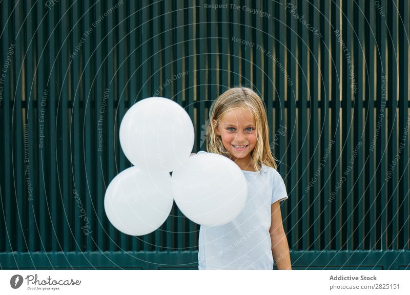 Charming girl with white balloons Girl Street Expression Posture Feasts & Celebrations Relaxation Happiness Summer Playful Vacation & Travel Town Outstretched