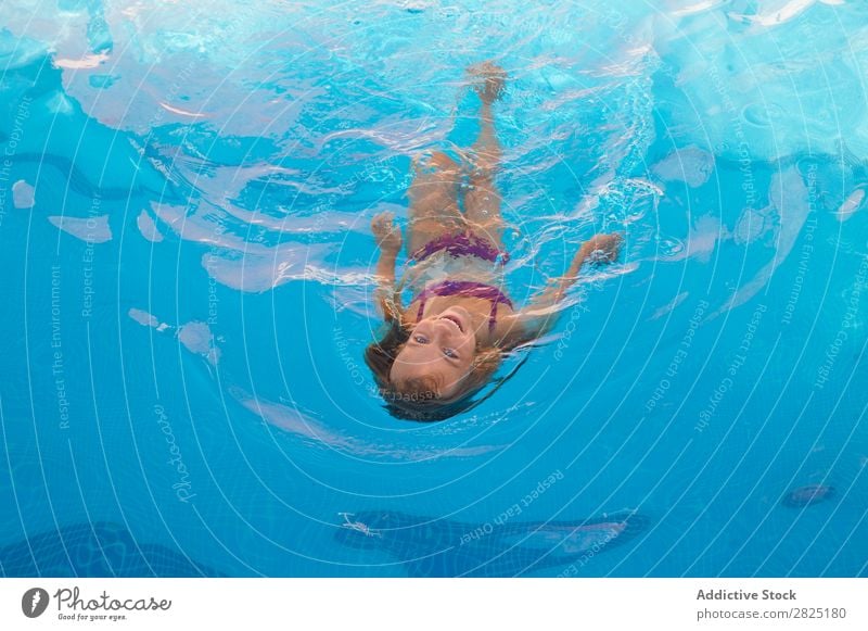 Child swimming in pool Swimming pool Floating human face Infancy Summer Vacation & Travel Water Girl Relaxation Action Swimmer (professional sportsman) Healthy
