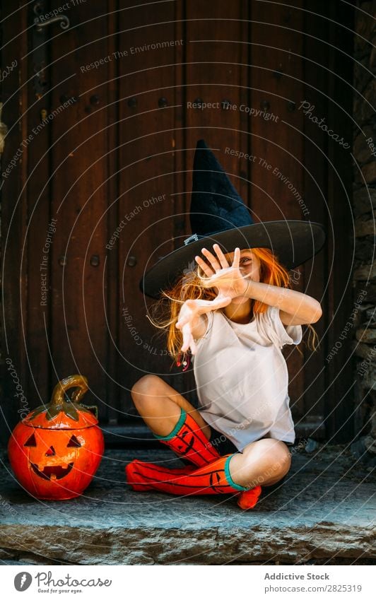 Adorable girl posing playfully Girl Hallowe'en pretend terrify Posture Portrait photograph Cheerful House (Residential Structure) Costume Feasts & Celebrations