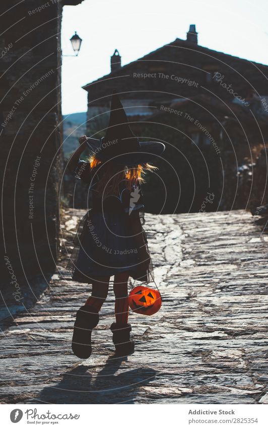 Kid with pumpkin in Halloween Child Hallowe'en Street Costume Witch Tradition Carnival Vacation & Travel Autumn Bucket Culture Girl Holiday season