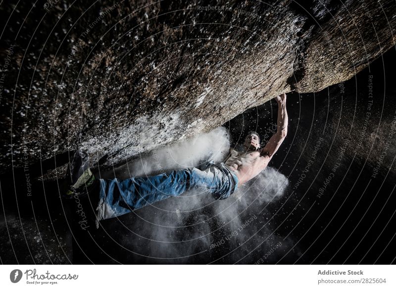 A man climbing on the rock from magnesium, mountain at dusk. Creativity Human being Chalk Climbing Strong Athletic decisions Energy Fingers Stone block Action