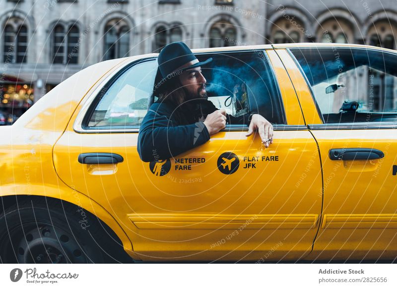 Smoking man looking out of taxi Man Ride Taxi Vehicle Hat bearded Cigarette Self-confident Earnest Street Brutal Beard Human being City Hipster Adults Easygoing