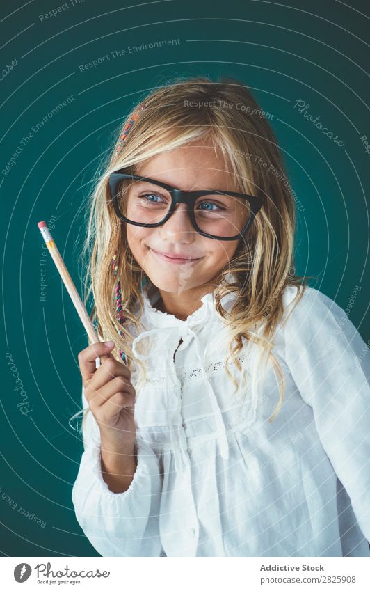 Cute schoolgirl with pencil Girl Classroom Blackboard Person wearing glasses Pencil Smiling Cheerful Stand Education School Grade (school level) Student