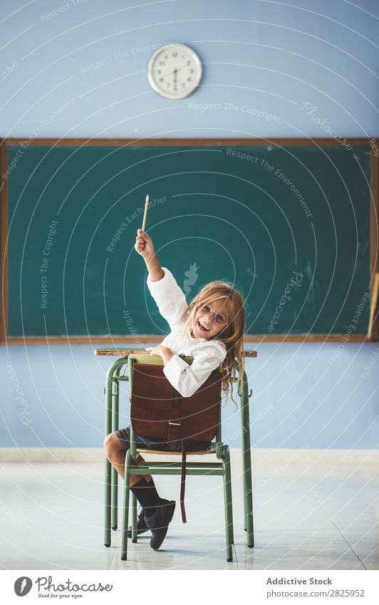 Smiling girl with pencil in class Girl Classroom Blackboard Sit Looking into the camera Pencil Happy Cheerful hand up Cute Education School Grade (school level)
