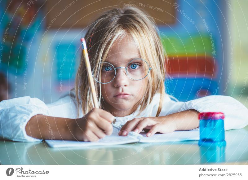 Thoughtful girl writing in class Girl Classroom Sit Desk Writing Pencil Drawing Think Considerate bored Cute Education School Grade (school level) Student
