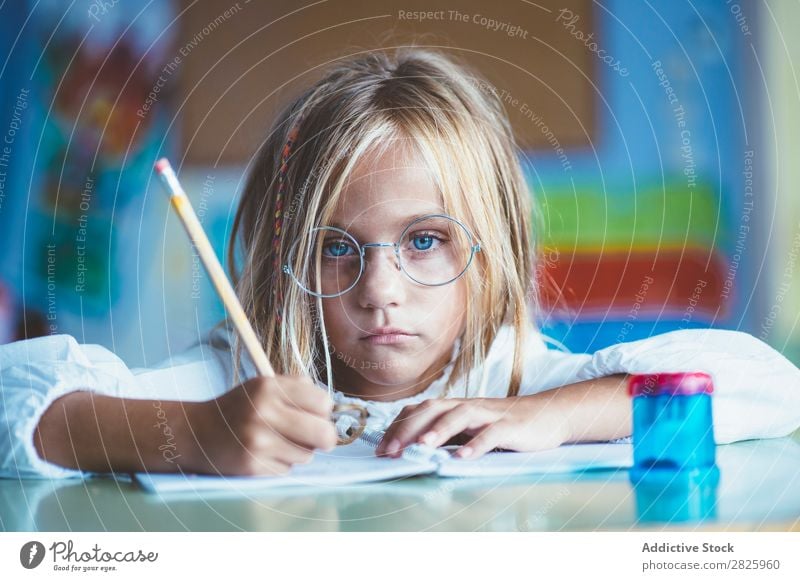 Thoughtful girl writing in class Girl Classroom Sit Desk Writing Pencil Drawing Think Considerate bored Cute Education School Grade (school level) Student