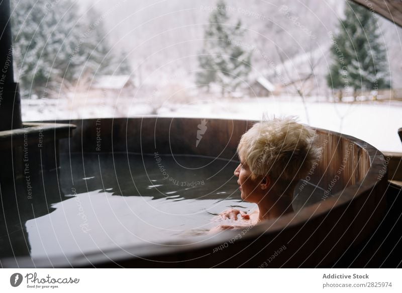 Blonde woman swimming in outside plunge tub Woman Swimming Nature Winter Water Healthy Beautiful Vacation & Travel Romania Float in the water Snow Ice Natural