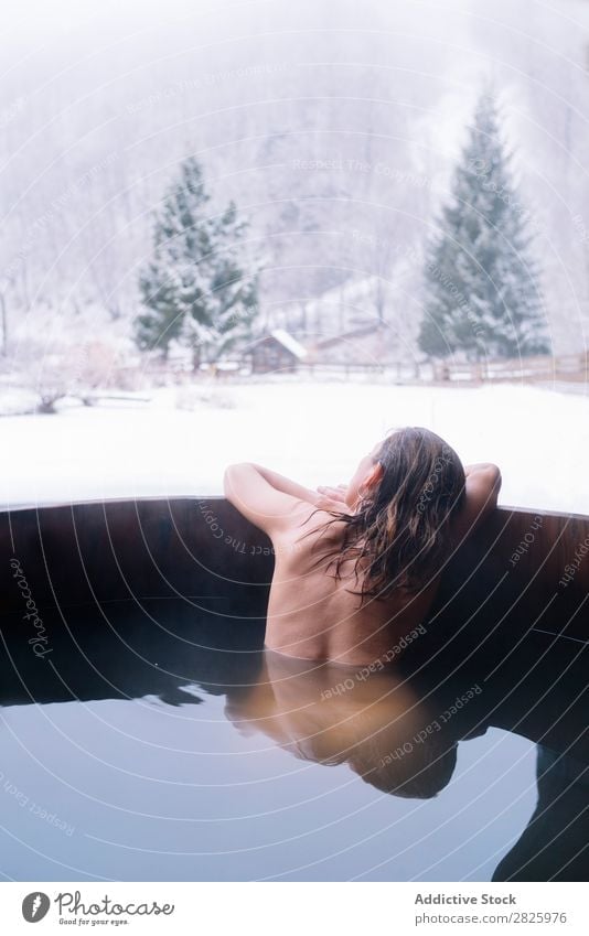 Woman swimming in outside tub Swimming Nature Winter plunge tub Water Healthy Beautiful Vacation & Travel Romania Float in the water Snow Ice Natural