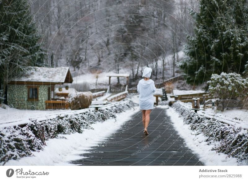 Woman in bathrobe walking to forest Nature Winter Walking Forest boardwalk Corridor Healthy Beautiful Vacation & Travel Romania Snow Bathrobe Ice Natural