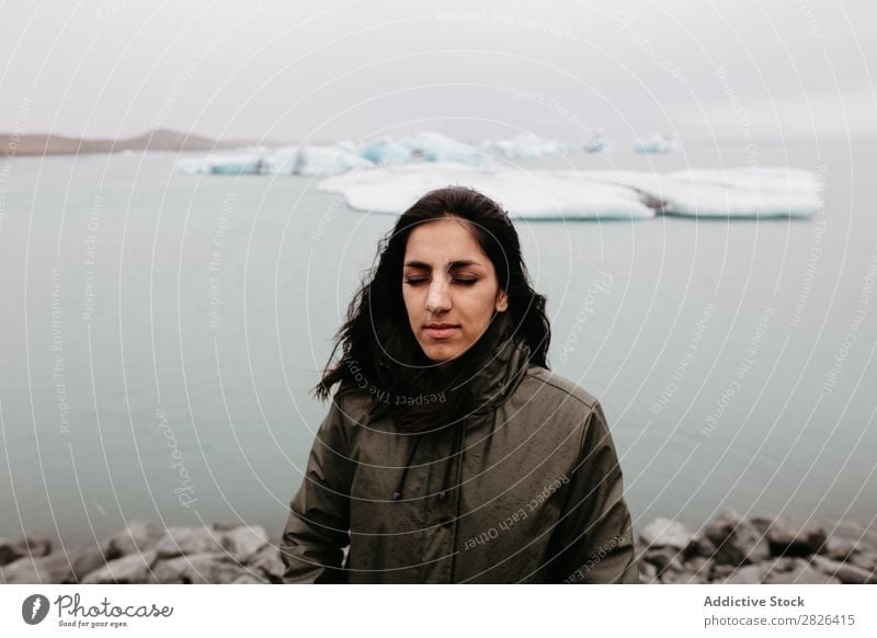 Woman on background of ice in ocean Ocean Glacier Nature Ice Landscape Vacation & Travel Tourism Iceland Environment Iceberg Winter White polar Water Posture