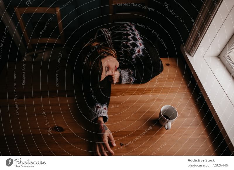 Woman lying on table with mug Table Sleep Iceland Home Morning exhausted Fatigue Dream asleep Stress Relaxation Interior shot Resting Mug Cup Refreshment