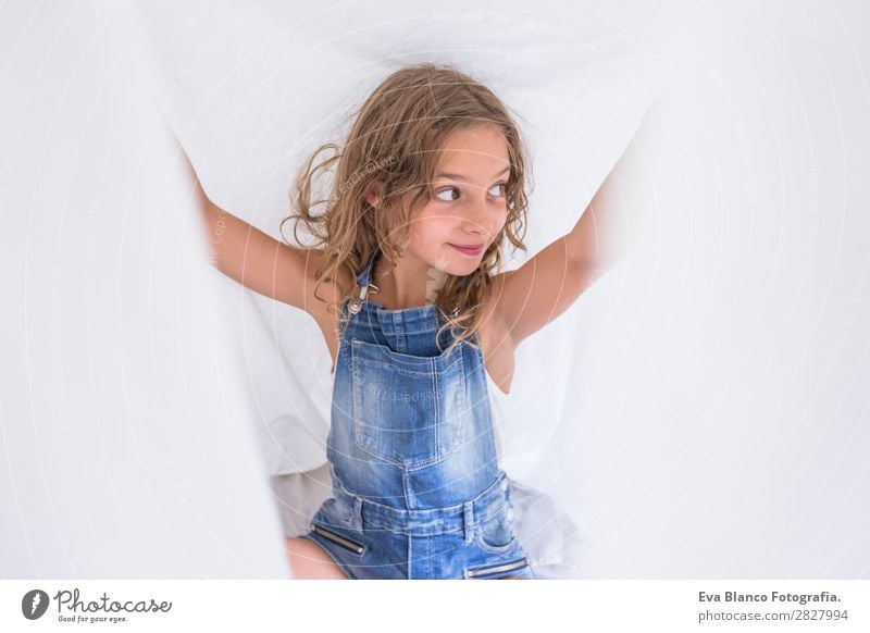 beautiful kid girl playing under white sheets on bed Lifestyle Joy Happy Beautiful Leisure and hobbies Playing Reading Summer Bedroom Child Human being Feminine