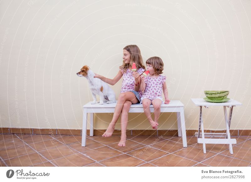 Two beautiful sister kids eating watermelon ice cream Fruit Ice cream Eating Joy Happy Vacation & Travel Summer House (Residential Structure) Garden Child