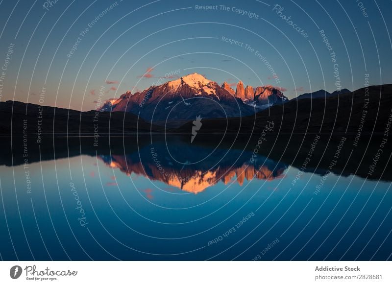 Calm water in mountain lake Landscape Lake Reflection Mountain Twilight Surface Snow Basin Tourism Blue Peak Mirror Panorama (Format) Water Environment Bright