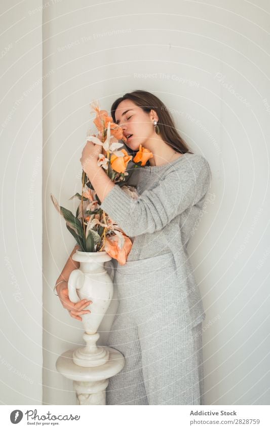 Sensual woman embracing flowers Woman pretty Youth (Young adults) Beautiful Flower Orange Vase Stand To enjoy eyes closed Brunette Attractive Human being
