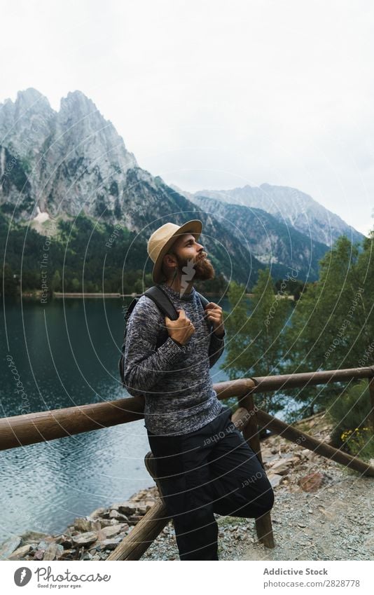 Handsome tourist at mountain lake Tourist Man Lake handsome bearded Nature Fence Wood Vacation & Travel Lifestyle Backpack Mountain Landscape Water