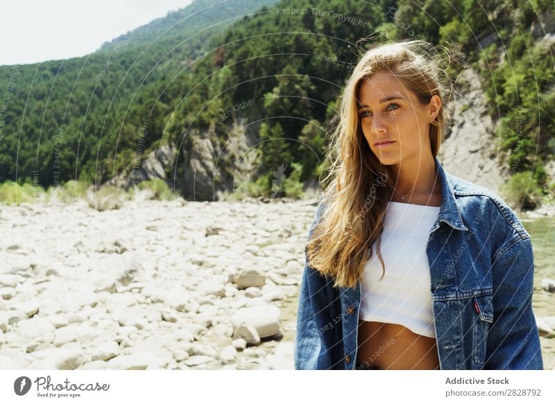 Happy girl posing on the stones of a river Woman Posture traveler trekking Tropical Mountain Rock Paradise Hiking enjoyment Tourism River Summer pose