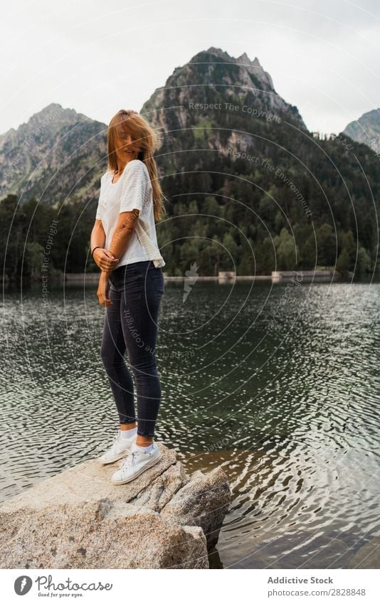 Woman sitting on stone at lake Stone Lake Mountain Nature Landscape Water Rock Beautiful Youth (Young adults) Hiking Vacation & Travel Adventure Trip trekking