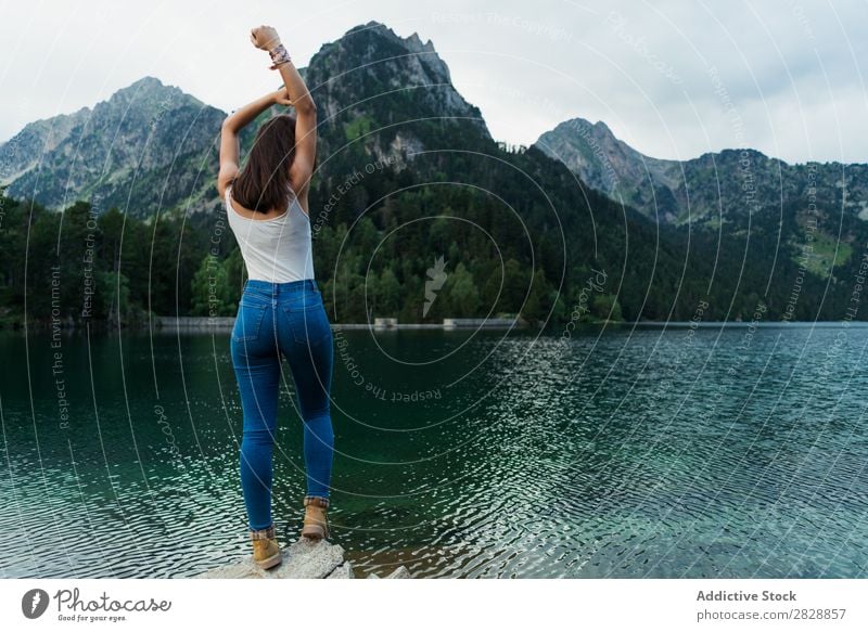 Stylish women sitting on rock in breathtaking landscape - a Royalty Free  Stock Photo from Photocase