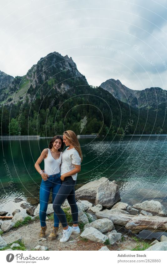 Women at lake in mountains Woman Mountain Walking Hiking Lake Water embracing Smiling Cheerful Happy Vacation & Travel Adventure Tourist Youth (Young adults)