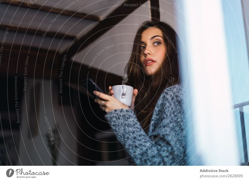 Young adult white woman with big cup of latte - a Royalty Free Stock Photo  from Photocase