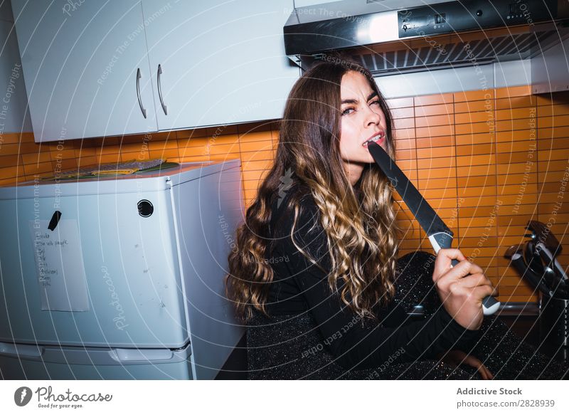 Expressive woman posing with knife Woman pretty Posture Knives Anger Sit Table Dangerous Home Kitchen Beautiful Lifestyle Youth (Young adults) Human being Happy