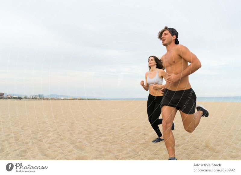Two sportsmen running on beach Couple Beach Running Sports Human being Athletic workout Coast Action Jogging Fitness Runner Together Speed Exterior shot
