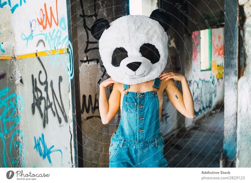 Topless woman in abandoned building with plush panda head Woman Posture Eroticism Hot To enjoy Attractive Covering Breasts Easygoing Looking into the camera