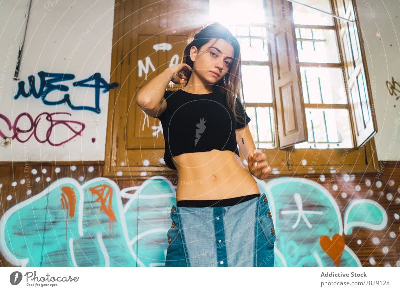 Woman posing in abandoned building Building Cheerful Posture Graffiti Attractive To enjoy Hair Set Youth (Young adults) Portrait photograph Beautiful Lifestyle