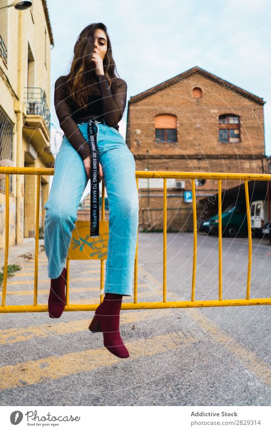 Woman sitting at fence Style Street Town Posture Sit Fence Asphalt Portrait photograph Attractive Beauty Photography Hip & trendy Lifestyle pretty Fashion