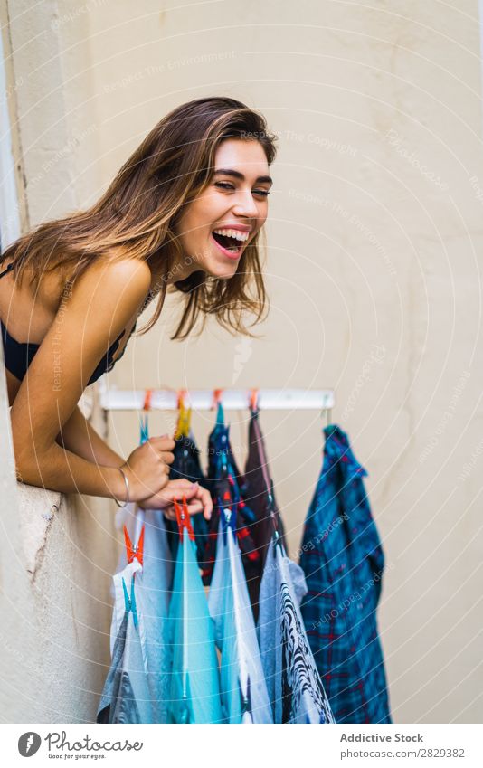 Cheerful woman looking out of window Woman Home Youth (Young adults) Beautiful Window Posture Laughter hanging out Linen drying To enjoy Attractive Hot pretty
