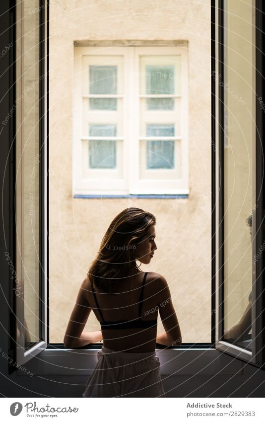 Attractive woman holding hair at window Woman Home Youth (Young adults) Beautiful Window Posture To enjoy Hot pretty Beauty Photography Happy Human being Room