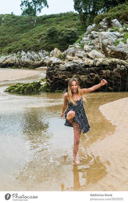 Cheerful girl playing in water Woman Water Beach having fun Splashing Nature Happiness Vacation & Travel Summer Rock Tropical Playing Action Style Playful