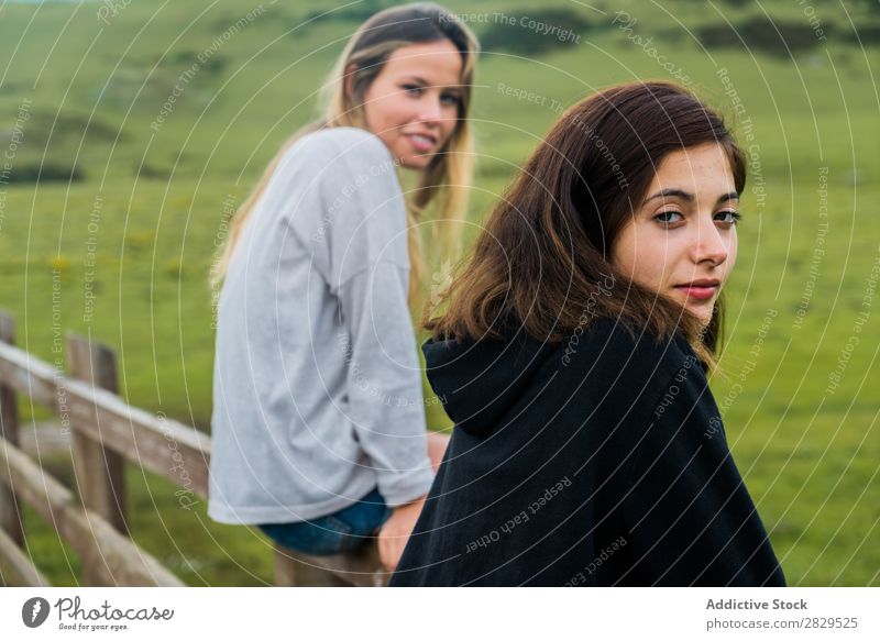 Women sitting at mountain pasture Woman Meadow Sit Handrail Relaxation Mountain Cow Pasture Nature Field Girl Grass Beautiful Youth (Young adults) Green Spring