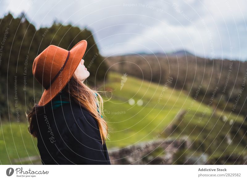 Woman sitting on fence at field Sit Field Green Nature Meadow Fence Relaxation Rest Looking away Hat Spring Summer Grass Landscape Agriculture Rural Sunlight