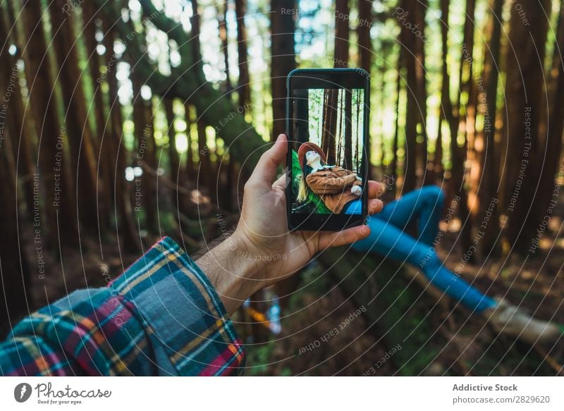 Hand taking shot of relaxing woman Woman Tourist Forest Green Nature shots Trunk Relaxation Lie (Untruth) PDA Screen Environment pretty Natural Seasons Plant