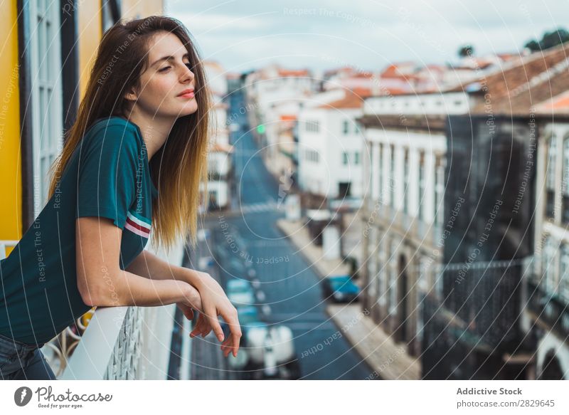 Charming brunette on balcony in cityscape Woman Balcony Dream Skyline Considerate romantic Pensive Vacation & Travel Beauty Photography Easygoing Think tender