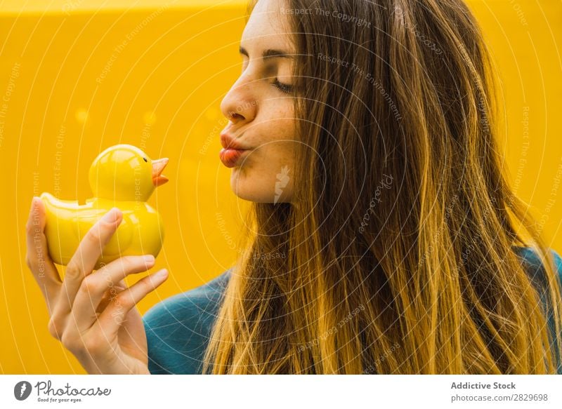 Charming woman with rubber duck Woman Contentment giving Beauty Photography outstretch Innocent Cheerful Playing Bright Freedom Offer human face
