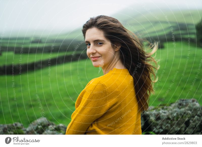 Smiling woman at green field Woman Field Green Vantage point Tourism Vacation & Travel Stand Nature Fence Landscape Stone Fog Grass Meadow Rural Clouds Seasons