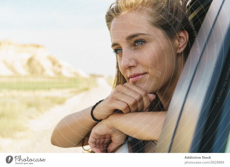 Woman looking out of car window Car Window riding Passenger Youth (Young adults) Vehicle Trip Vacation & Travel Girl Human being Street Beautiful Face Transport