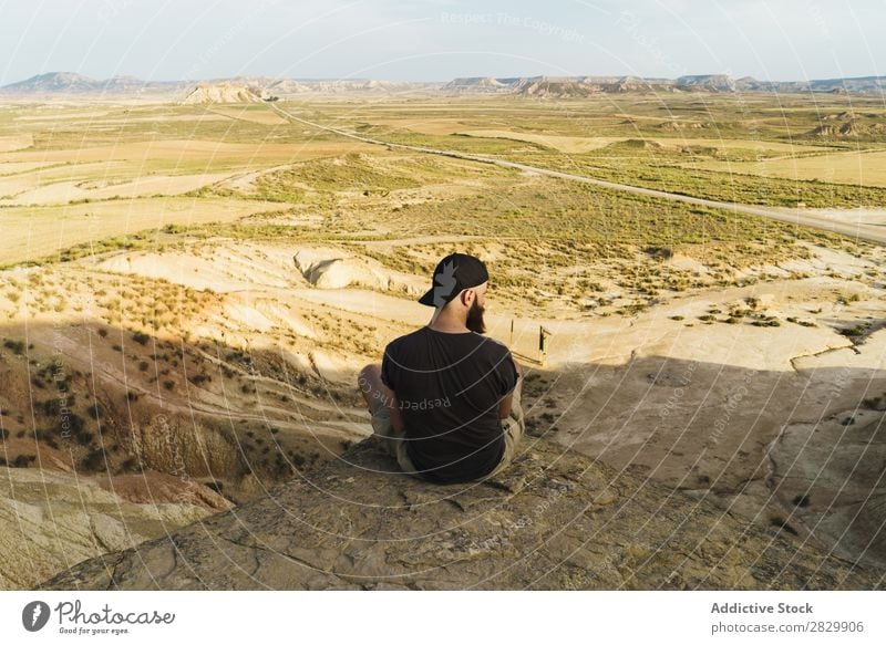 Man relaxing on cliff Cliff Sit Relaxation Edge Vacation & Travel Adventure Rock Mountain Tourist Freedom Vantage point Top Extreme Action Peak Nature Hiking