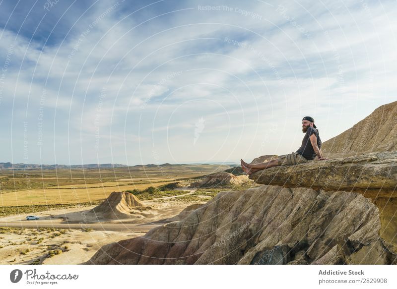 Man relaxing on cliff Cliff Sit Relaxation Edge Vacation & Travel Adventure Rock Mountain Tourist Freedom Vantage point Top Extreme Action Peak Nature Hiking