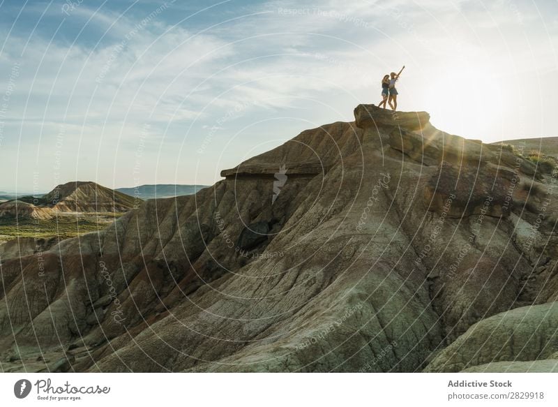 Women posing on cliff Woman Cliff Excitement Stand Hands up! Freedom Vacation & Travel Success Top Mountain Youth (Young adults) Nature Rock Landscape Happy