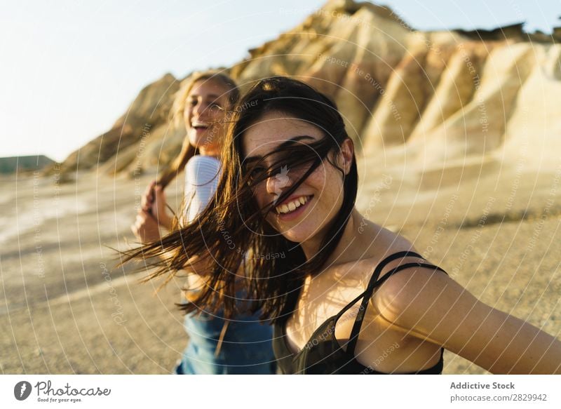 Pretty women walking at hill Woman Excitement Looking into the camera flying hair Walking Cheerful Freedom Vacation & Travel Success Top Mountain