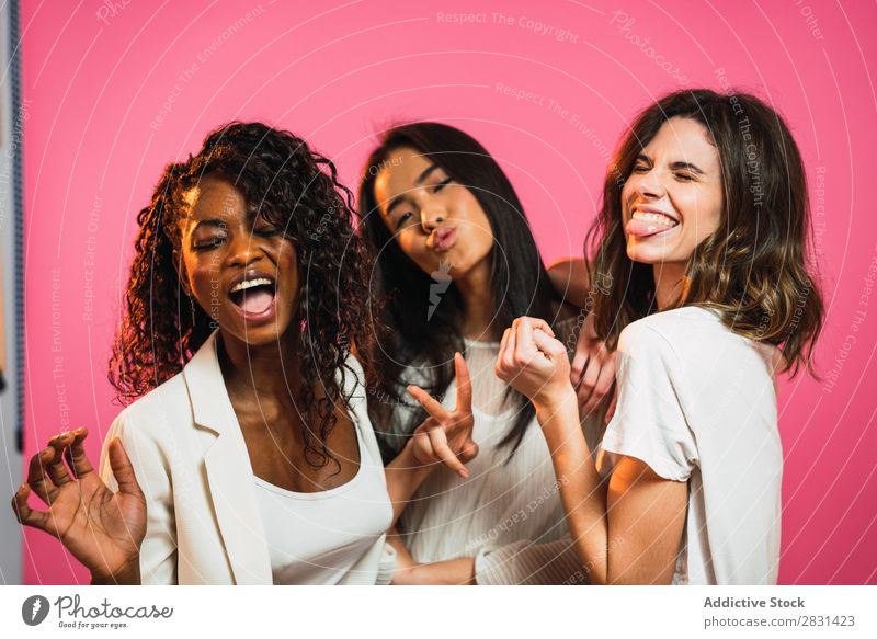 Cheerful multiracial women friends posing - a Royalty Free Stock