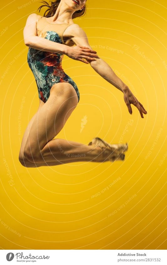 Woman jumping in studio - a Royalty Free Stock Photo from Photocase